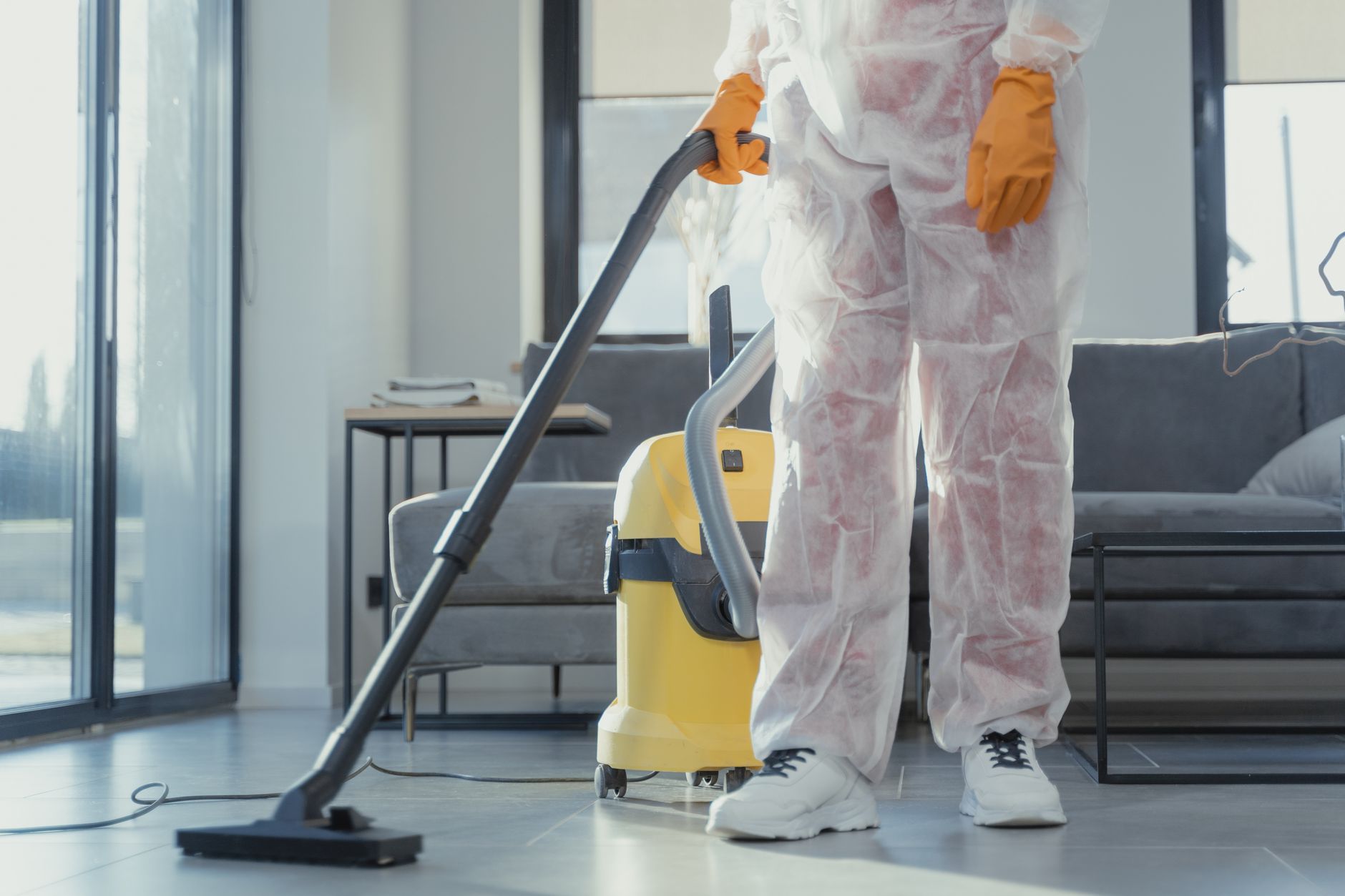 A professional mold remediation technician explaining the process to a Grand Prairie homeowner, pointing to a moisture reading.